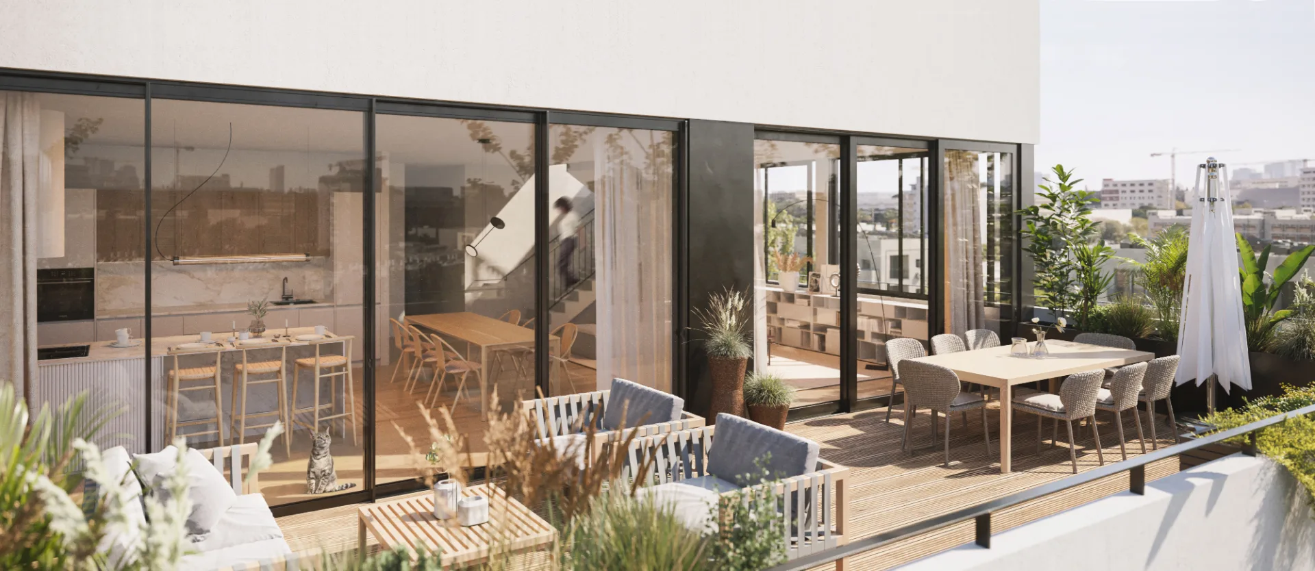 Grande terrasse avec salon extérieur et cuisine ouverte